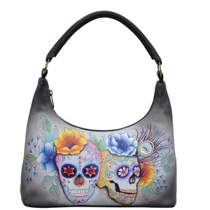 Anuschka style 371, handpainted Medium Zip Top Hobo. Calaveras de Azucar Painted in Grey Color. Featuring Inside zippered wall pocket two multipurpose pockets and rear zip pocket.