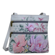 Load image into Gallery viewer, Anuschka style 447, handpainted Medium Crossbody With Double Zip Pockets. Bel Fiori Painted in Grey Color. Featuring three multipurpose pockets and key holder and rear optical case with hook and loop fastener.
