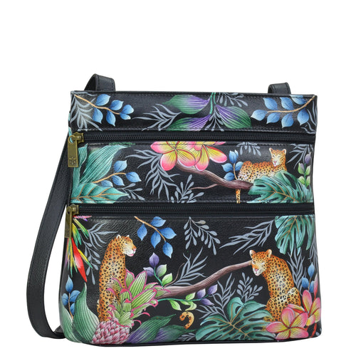 Anuschka style 447, handpainted Medium Crossbody With Double Zip Pockets. Jungle Queen Painted in Black Color. Featuring three multipurpose pockets and key holder and rear optical case with hook and loop fastener.