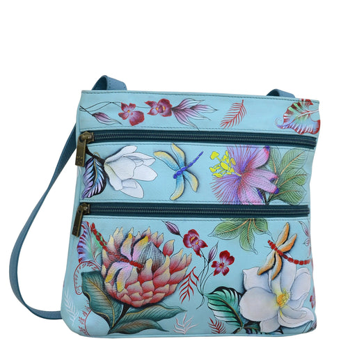 Anuschka style 447, handpainted Medium Crossbody With Double Zip Pockets. Jardin Bleu Painted in Blue Color. Featuring three multipurpose pockets and key holder and rear optical case with hook and loop fastener.