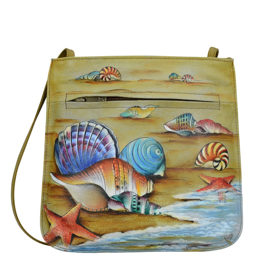 Anuschka style 452, handpainted Slim Crossbody With Front Zip. Gift of the Sea Painted in Yellow Color. Featuring inside zippered wall pocket, cell phone pocket, Key holder, front zip pocket and rear slip pocket with removable fabric optical case.