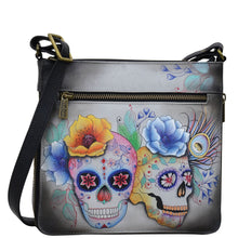 Load image into Gallery viewer, Anuschka style 550, handpainted Expandable Travel Crossbody. Calaveras de Azúcar Painted in Grey Color. Featuring inside one full length zippered wall pocket, one open wall pocket, two multipurpose pockets.
