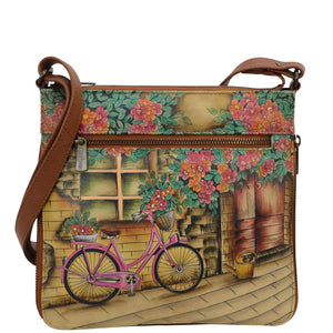 Anuschka style 550, handpainted Expandable Travel Crossbody. Vintage bycicle Painted in Tan Color. Featuring inside one full length zippered wall pocket, one open wall pocket, two multipurpose pockets.