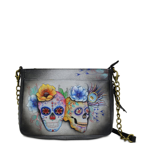 Anuschka style 636, handpainted Compact Crossbody With Front Pocket. Calaveras de Azucar Painted in Grey Color. Featuring front full length pocket with magnetic button and extended zippered gusset.