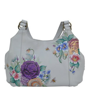 Anuschka style 652, handpainted Triple Compartment Large Satchel. Floral Charm painting in grey color. Fits Tablet and E-Reader. Removable fabric optical case, cosmetic pouch and metal logo keycharm.
