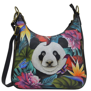 Anuschka style 662, handpainted Convertible Slim Hobo With Crossbody Strap, Happy Panda painting in Green color. Featuring two multipurpose pockets with gusset. slip in cell pocket.