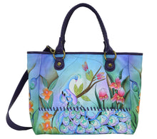 Load image into Gallery viewer, Anuschka style 7332, handpainted Large Tote. Midnight Peacock painting in blue color. Featuring double magnetic snap button entry to main compartment, inside zippered wall pocket, one open wall pocket, two multipurpose pockets, rear full length zippered pocket and slip in cell pocket.
